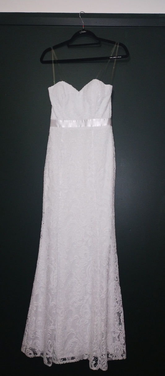 White sheath, sweetheart neckline. Satin ribbon waist detail. Princess line, skirt flares from knee. All lace and lined.