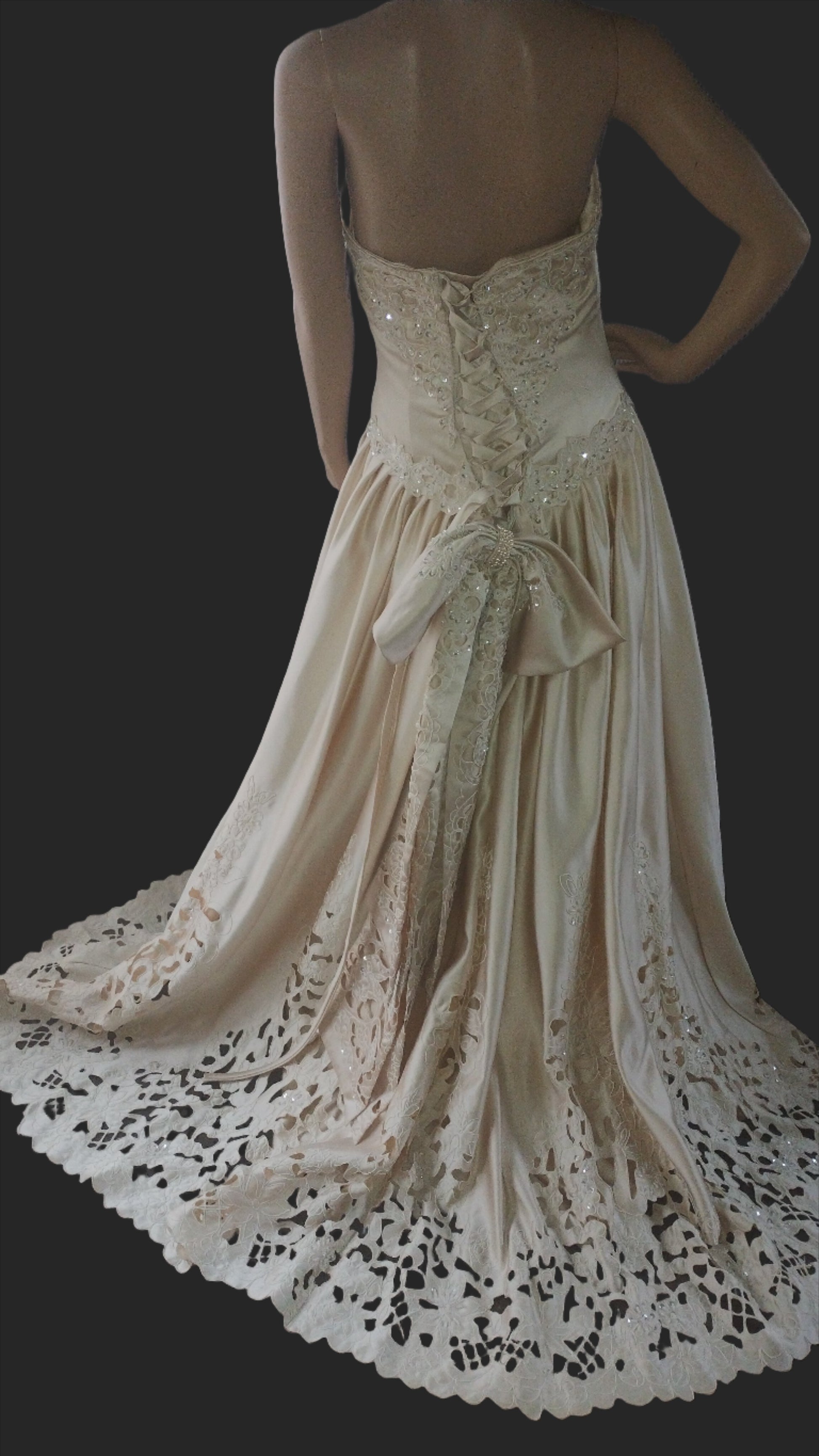 back view of dress. light golden colour. corset back ending in outsize bow.