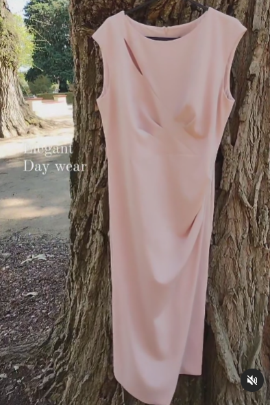 High scoop neckline, unique darted to centre bodice, little accent slit under neckline to side.  straight skirt to knee, gathered to hip , slit.